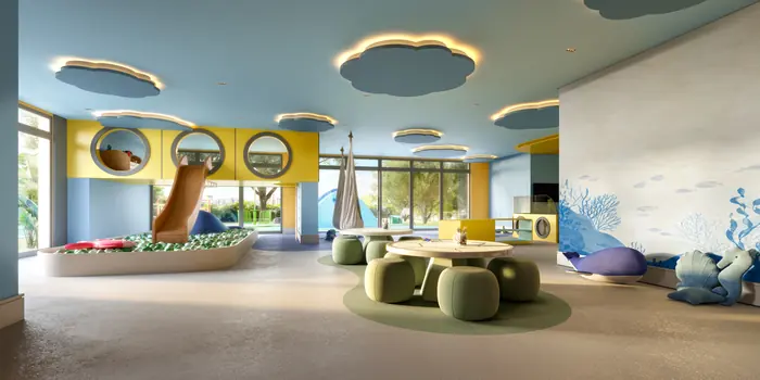 Brinquedoteca com piscina de bolinhas, escorregador, mesa redonda e almofadas em forma de baleia