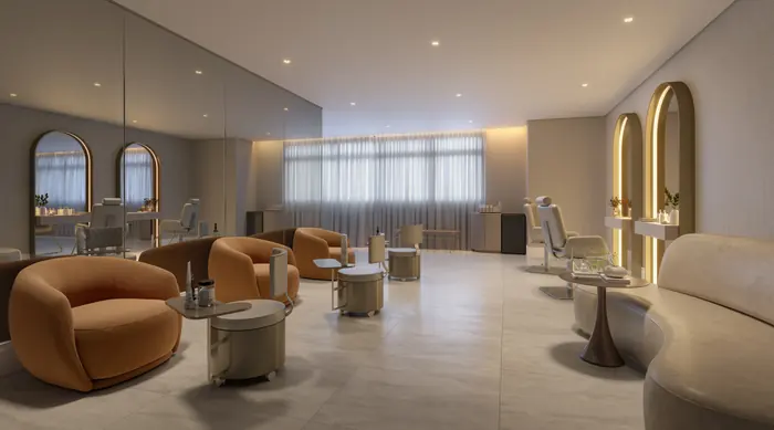 Espaço beleza com poltronas laranja, espelhos arqueados e estações de atendimento junto à parede